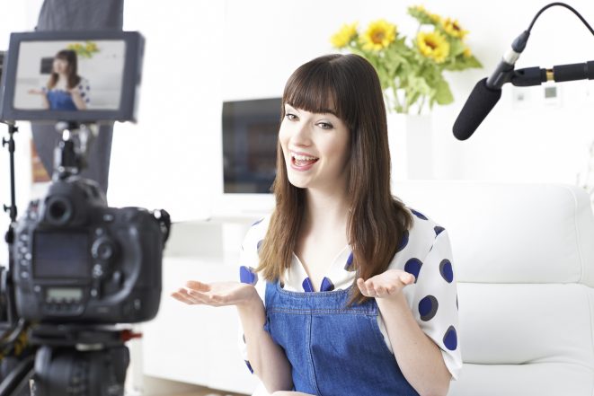 how to make videos - female vlogger on camera 